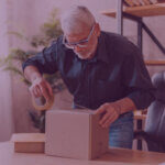 A man boxing up a parcel to return to Amazon