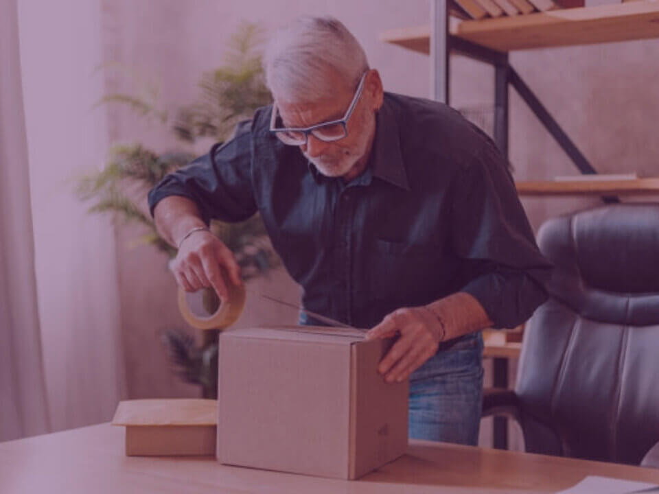 A man boxing up a parcel to return to Amazon