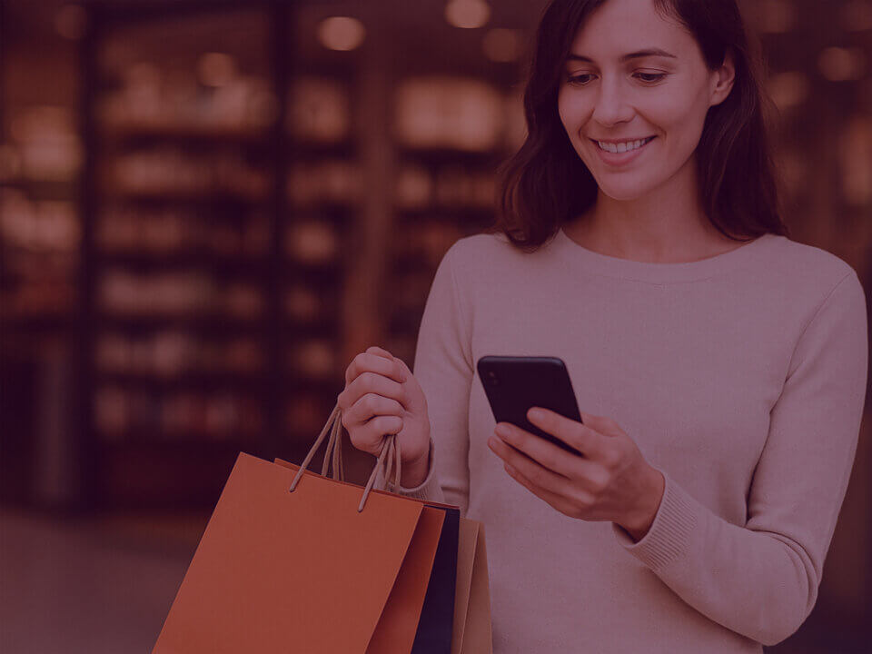 What Smart Brands will do differently now Prime Day is 4 days long - Venture Forge Image of women shopping during busy sales periods and ordering stuff on Amazon on her phone.