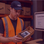 Image of an Amazon worker inspecting returned packages to see if they're eligible for reselling.