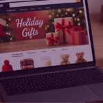Amazon Holiday Gifts webpage on laptop - Venture Forge Laptop screen displaying Amazon’s Holiday Gifts page with wrapped presents and Christmas decorations.