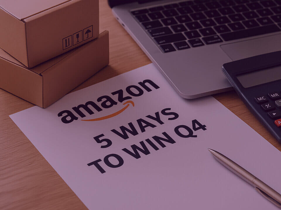 Amazon Q4 strategy guide - Venture Forge Paper with the text “Amazon – 5 Ways to Win Q4” on a desk with laptop, calculator, pen, and shipping boxes.