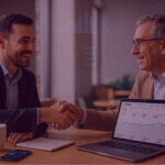 Two professionals shaking hands over an Amazon performance dashboard, representing human connection and data-driven growth.