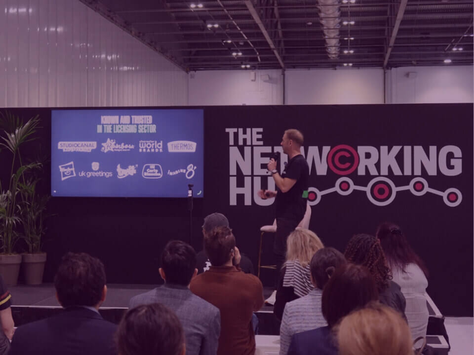 Andy Banks presenting at The Networking Hub event about Amazon strategy for licensed brands, with audience in attendance.