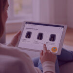 Reviewing Amazon Product Performance on Tablet – Venture Forge - Venture Forge Team member reviewing product listings and performance data on a tablet in a modern office setting.