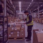 Amazon FBA Removal Fee Inventory Processing - Venture Forge Warehouse worker scanning individual items from a pallet in a fulfilment centre inventory area.