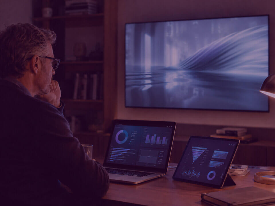 Senior media strategist reviewing Amazon DSP and LinkedIn CTV campaign performance on a connected TV dashboard