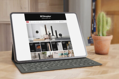 Glen Dimplex Amazon Case Study 1 - Venture Forge Tablet displaying an online store homepage with lighting/heating products on a wooden desk, beside a potted cactus.